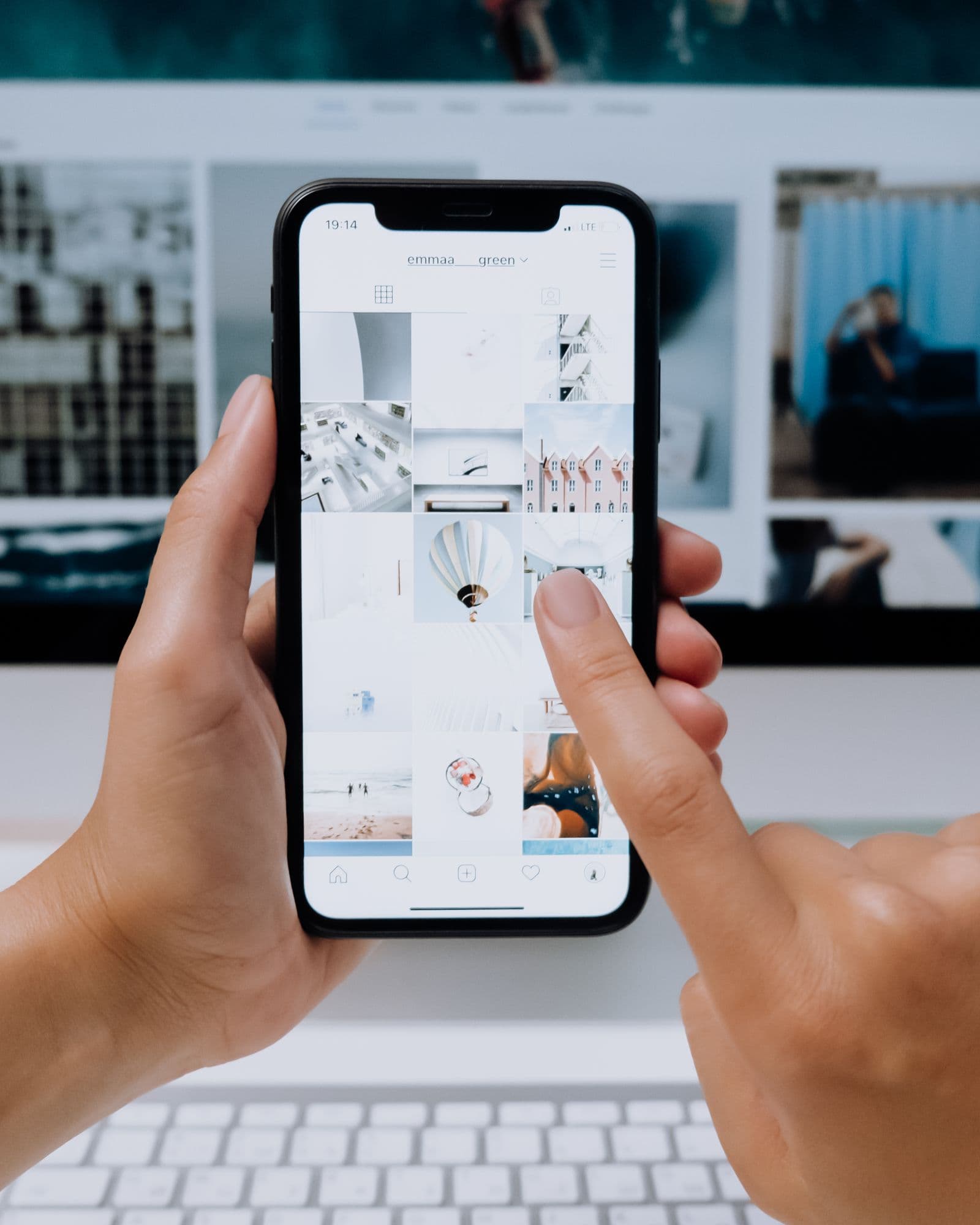 Hands browsing personal photos on an iPhone
